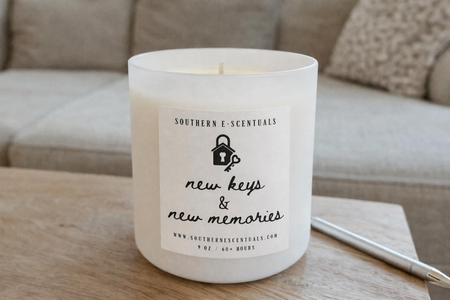 New Keys and New Memories white tumbler soy candle on a writing desk